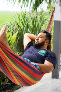 Low angle view of woman sitting on hammock