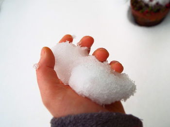 Close-up of hand holding ice cream