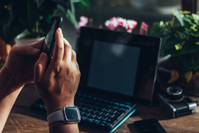 Midsection of man using smart phone