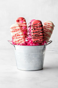 Homemade valentine cakesickles in a metal pail, against a light background.