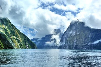 View of calm sea against mountain range