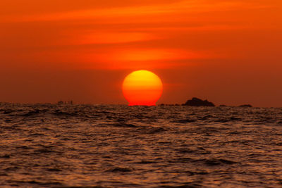 Scenic view of sea against orange sky