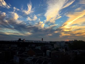 Cloudy sky above city at sunset