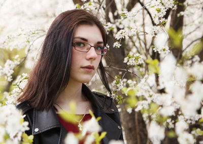 Portrait of beautiful woman with red flower