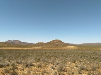 Scenic view of arid landscape against clear sky