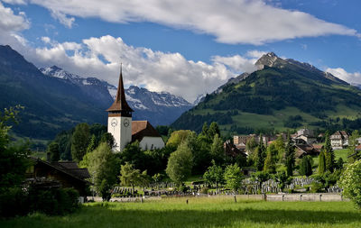 Panoramic view of trees and buildings against sky