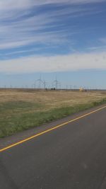 Road by landscape against sky