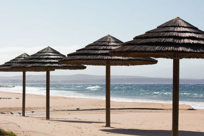 Built structure on beach against clear sky