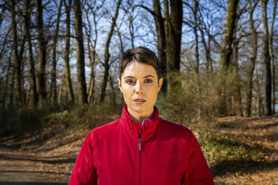 Portrait of young woman standing in forest