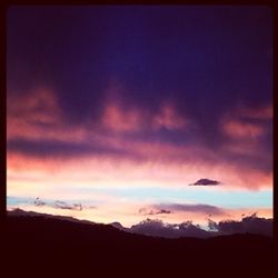 Scenic view of mountains against cloudy sky