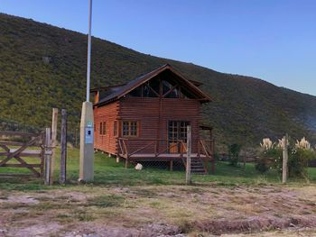 House on field against clear sky