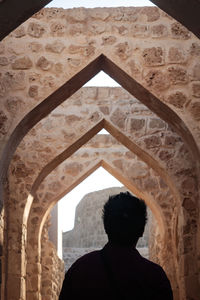 Rear view of man in historic building