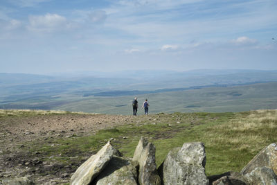 Rear view of two people hiking