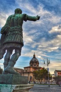 Low angle view of statue of temple against cloudy sky