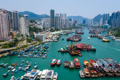 High angle view of boats moored at harbor in city