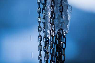 Close-up of icicles against clear blue sky