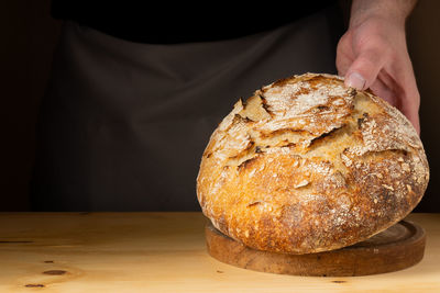 Midsection of person holding bread