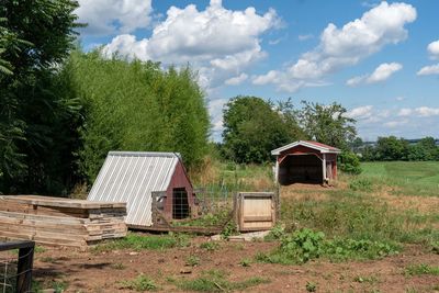 Abandoned house on field against sky