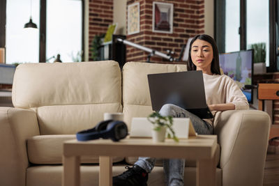 Businesswoman using laptop at home