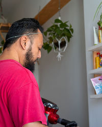 Side view of man wearing sunglasses at home