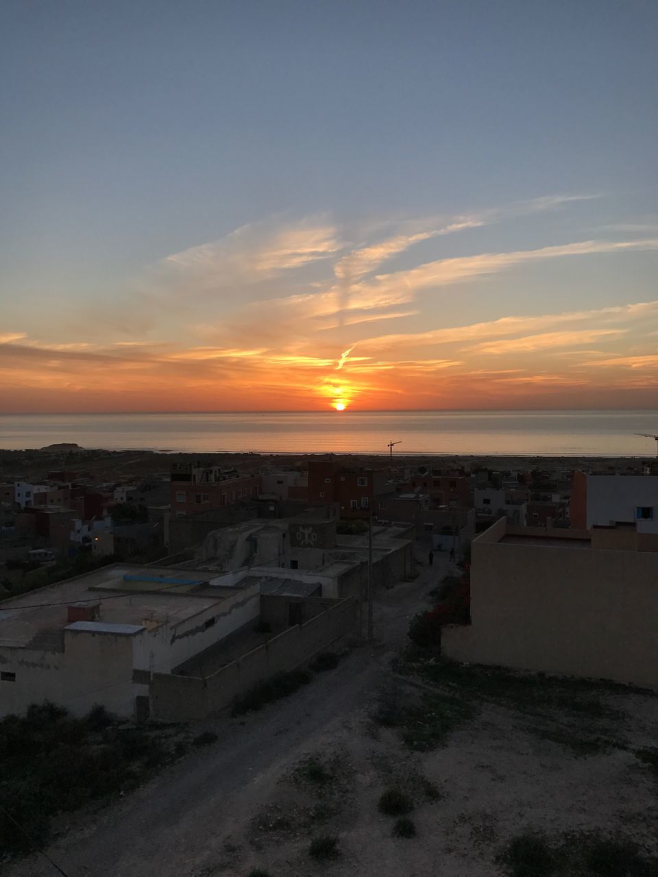 architecture, sunset, building exterior, built structure, sky, high angle view, sea, city, cloud - sky, residential building, outdoors, no people, travel destinations, beach, scenics, horizon over water, beauty in nature, nature, water, cityscape, day