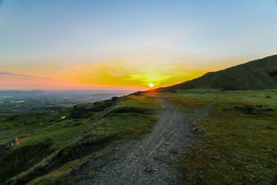 Scenic view of landscape against sky during sunset