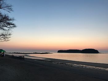 Scenic view of beach against sky during sunset