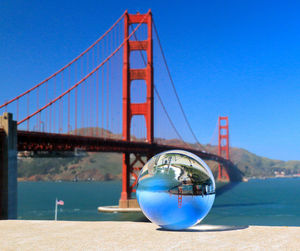 Low angle view of bridge against clear blue sky