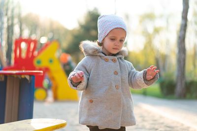 Cute girl at playground during winter