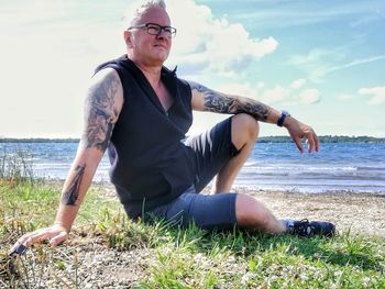Full length of mature man at beach against sky
