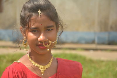 Portrait of a beautiful young woman on field