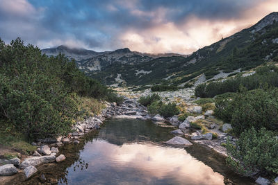 Scenic view of river amidst mountains against sky