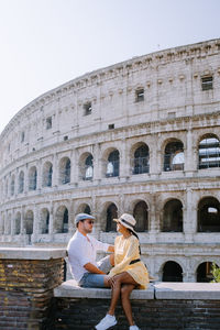 Full length of couple at historic building