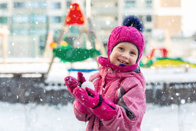 Portrait of smiling girl in snow