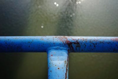 Close-up of wet metal railing during rainy season