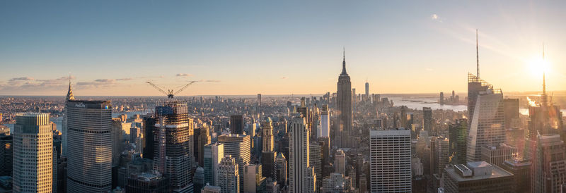 Aerial view of buildings in city during sunset