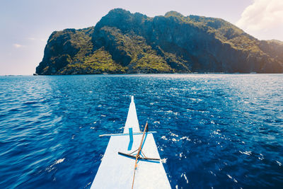 Sailboat sailing on sea against sky