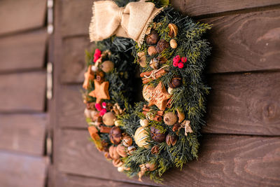 Close-up of pine cone hanging on wood