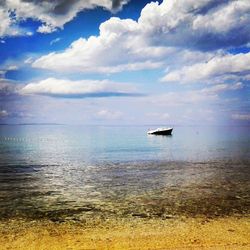 Scenic view of sea against cloudy sky