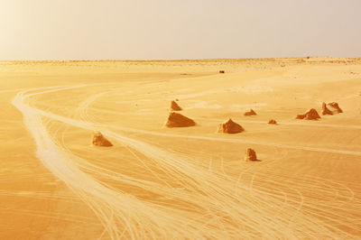 Sand dune in desert against clear sky