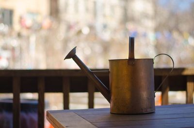 Watering can on table