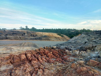 Rock formations on landscape against sky