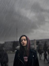 Woman standing outdoors during rainy season