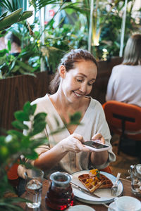 Woman having food at restaurant