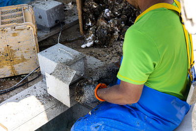 Midsection of man welding metal