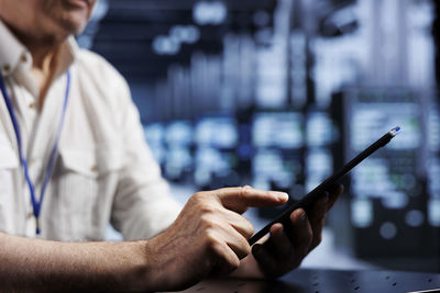 Midsection of woman using mobile phone