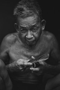 Portrait of senior man holding weapon