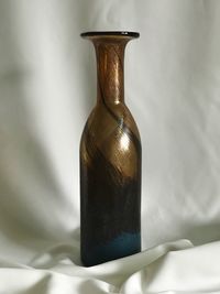 Close-up of empty glass bottle on table