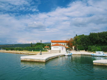 View of swimming pool by building against sky