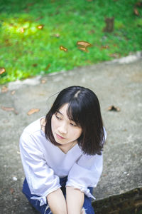 Portrait of a young woman sitting outdoors